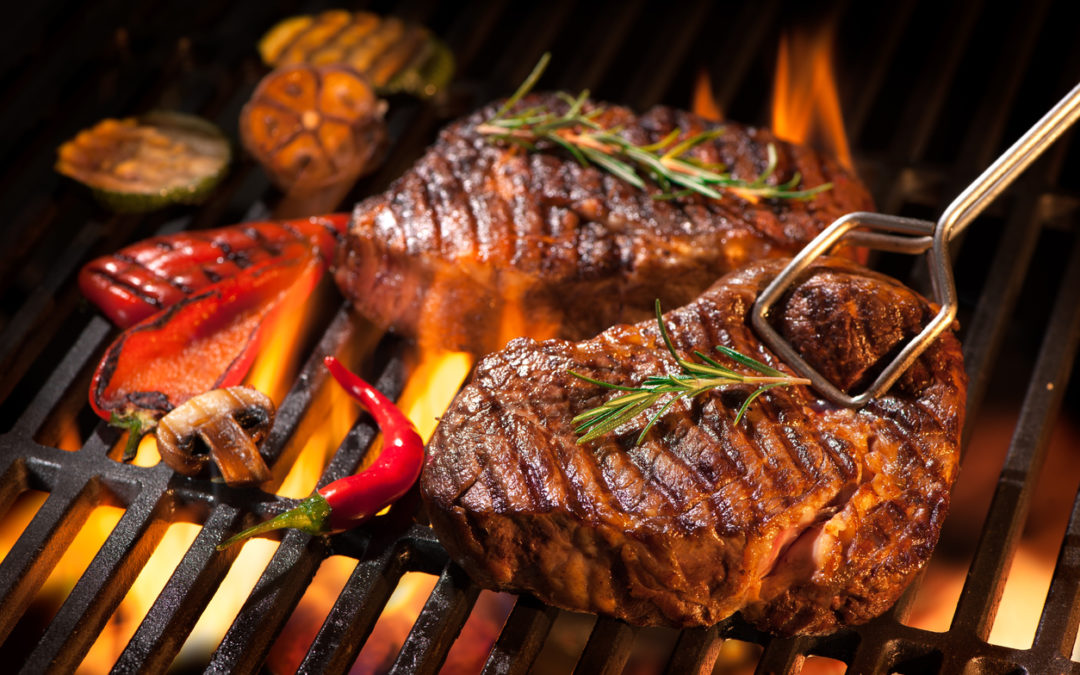 beef-steaks-on-the-grill-with-flames-charcoal-grill-vs-gas-grill